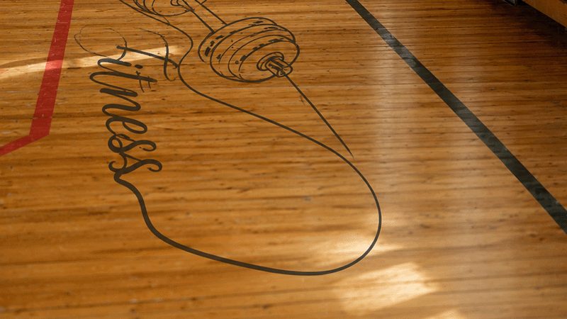 Custom fitness graphic printed on a gym floor